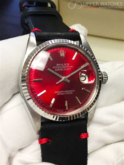 rolex watch with red dial.